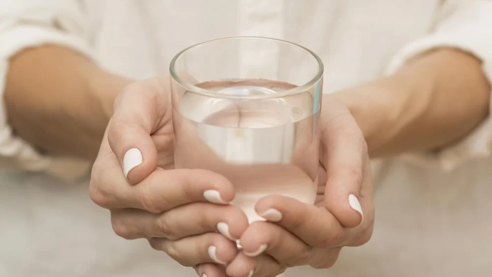 woman holding glass filled of water