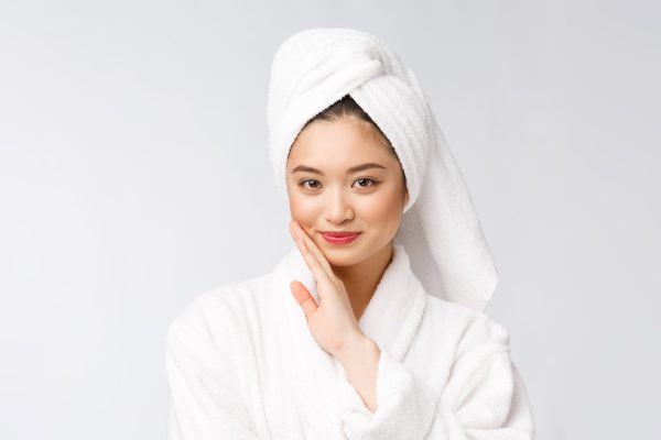 girl drying hair with towel